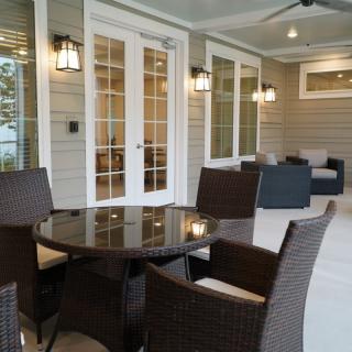 A cozy patio with wicker furniture and soft lighting, perfect for relaxing evenings.