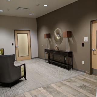 A modern interior lobby featuring a seating area and stylish wall decor.