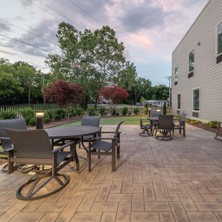 A spacious outdoor patio with seating and garden views.