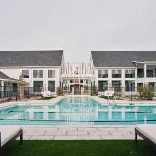 A luxurious resort with a large outdoor swimming pool and modern architecture.