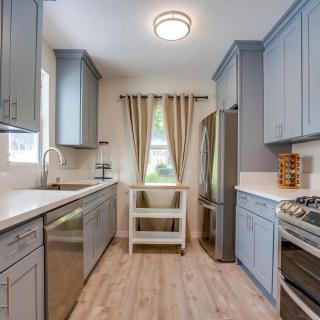 A modern kitchen with sleek cabinets, stainless steel appliances, and natural light streaming in through the window.