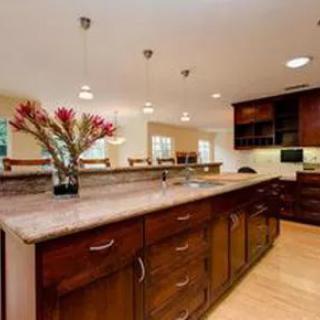 A modern kitchen with wooden cabinetry and a spacious countertop.