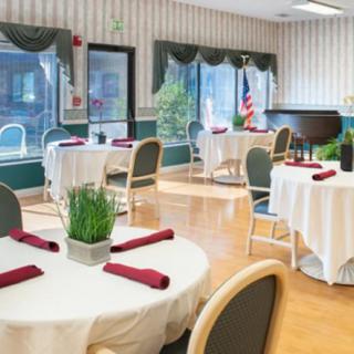 A well-decorated dining room with round tables set for guests.