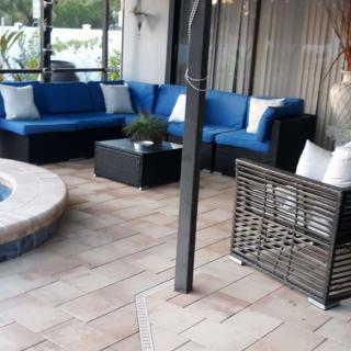 A cozy outdoor patio with blue cushioned seating and a small table.