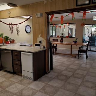 A decorated indoor kitchen area with festive balloons and garlands.