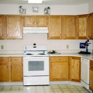 A clean, well-organized kitchen with wooden cabinets and modern appliances.