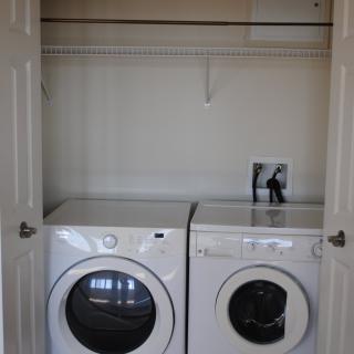 A minimalist laundry room with a washer and dryer set.