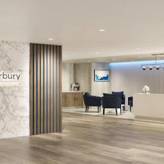 A modern office reception area featuring sleek design elements and comfortable seating.