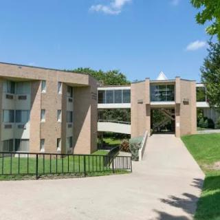 A view of a modern academic building situated on a well-maintained campus.
