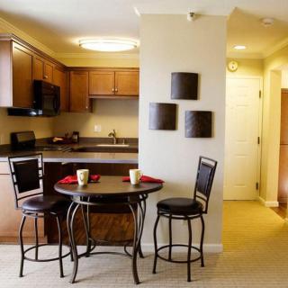A cozy kitchen and dining area with a modern table set.