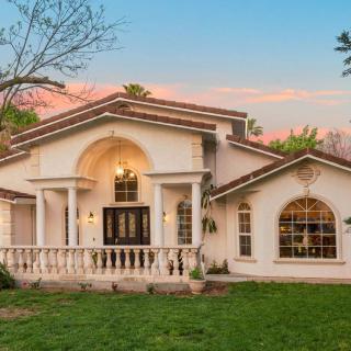 A beautiful residential house with a lawn at sunset.