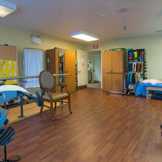 A rehabilitation room equipped with exercise equipment for physical therapy.