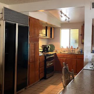 A modern kitchen featuring wooden cabinets and stainless steel appliances.