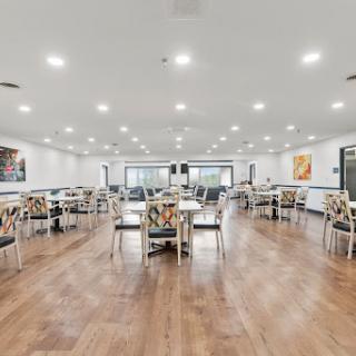 A spacious and modern dining area featuring well-lit interiors, elegant tables, and comfortable chairs.
