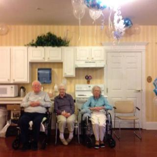 Three seniors sitting in a cozy kitchen-like setting.