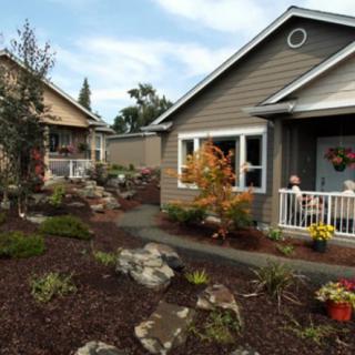 Charming cottages with well-maintained landscaping and a garden pathway.