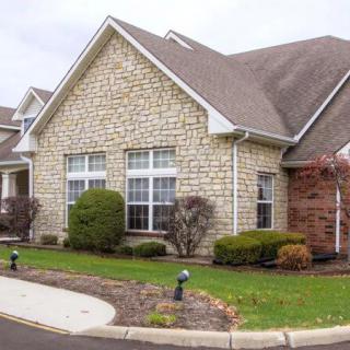 A suburban house with a brick exterior and well-maintained landscaping.