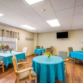 A bright and welcoming dining area with turquoise table covers, providing a cheerful atmosphere for gatherings.
