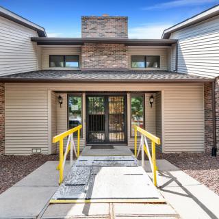 Front entrance of a residential building with a ramp.