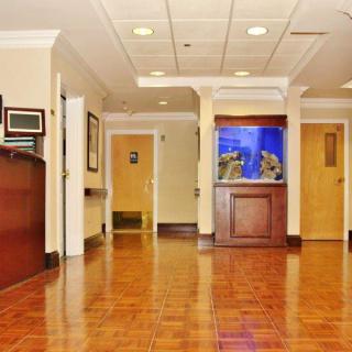 A spacious lobby area featuring a fish tank and tiled flooring.