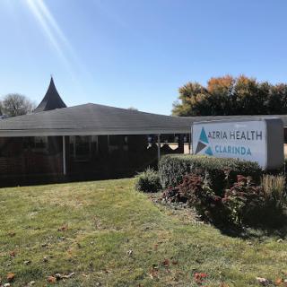 A healthcare facility with a clear sign, surrounded by well-maintained landscaping.