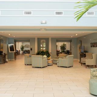 A spacious and modern lobby area with comfortable seating and decorative plants.