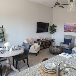 Modern living space with a cozy seating area, dining table, and stylish decor.