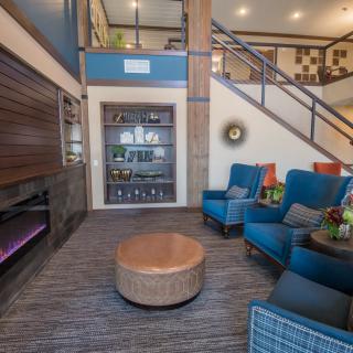 A modern living room with a cozy seating area and stylish decor.