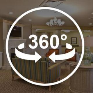 A 360-degree view of a cozy living room with comfortable seating and a warm atmosphere.