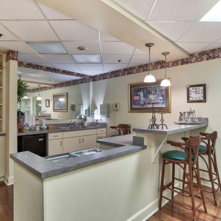 Home kitchen with a cozy bar seating area and warm lighting.