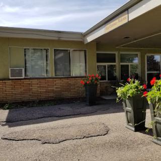 A view of a building with flower pots and an inviting entrance.