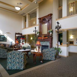A cozy hotel lobby with elegant furniture and a fireplace.