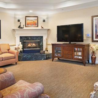 A cozy living room with a fireplace, television, and comfortable seating.