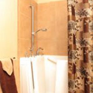 A bathroom with a bathtub and floral shower curtain.