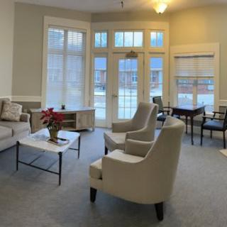A cozy living room with large windows and comfortable seating.