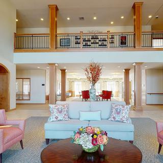 Spacious and elegantly designed living room with modern furniture and decor.