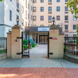An entrance gate leading to a residential apartment building in an urban setting.