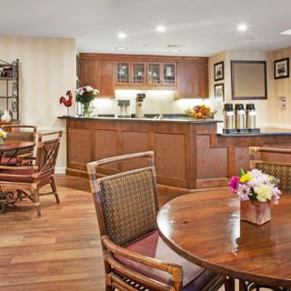 Cozy dining area with wooden furniture and floral decor.