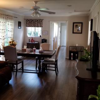 A cozy living room and dining area with warm lighting and elegant furnishings.