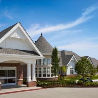 A picturesque suburban residential building under a clear blue sky.