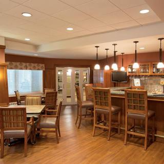 A cozy bar and dining area with wooden furniture and warm lighting.