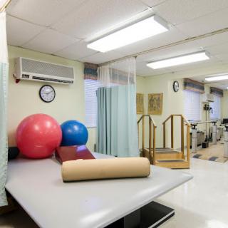A well-equipped physical therapy room featuring various exercise tools and equipment designed for rehabilitation.