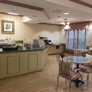 A cozy cafe interior with a serving counter and seating area.