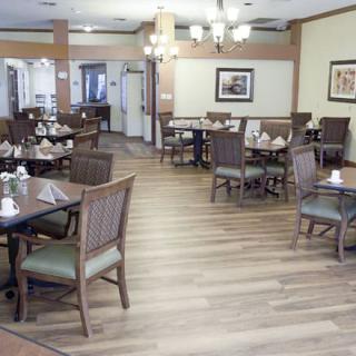 Empty dining area with neatly arranged tables and chairs in a restaurant.