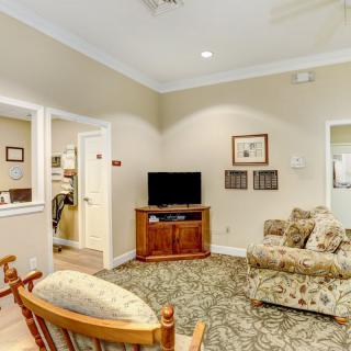 A cozy living room featuring a television, sofa, and warm decor.