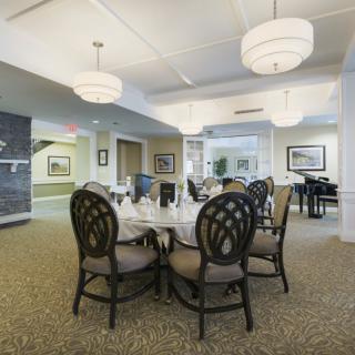 A modern dining room interior with elegant furniture and chandeliers.