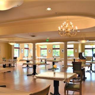 A spacious dining area featuring elegant furnishings and plenty of natural light.