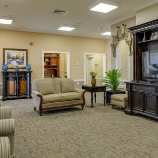 A cozy living room interior featuring a sofa, television, and decorative elements.