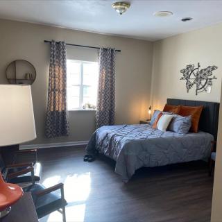 A cozy bedroom with modern decor and a comfortable bed.