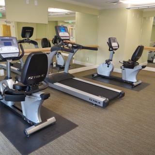 A small gym with treadmills and stationary bikes for exercise.